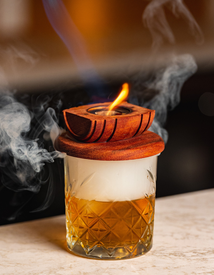 A smoked cocktail, lid lifting