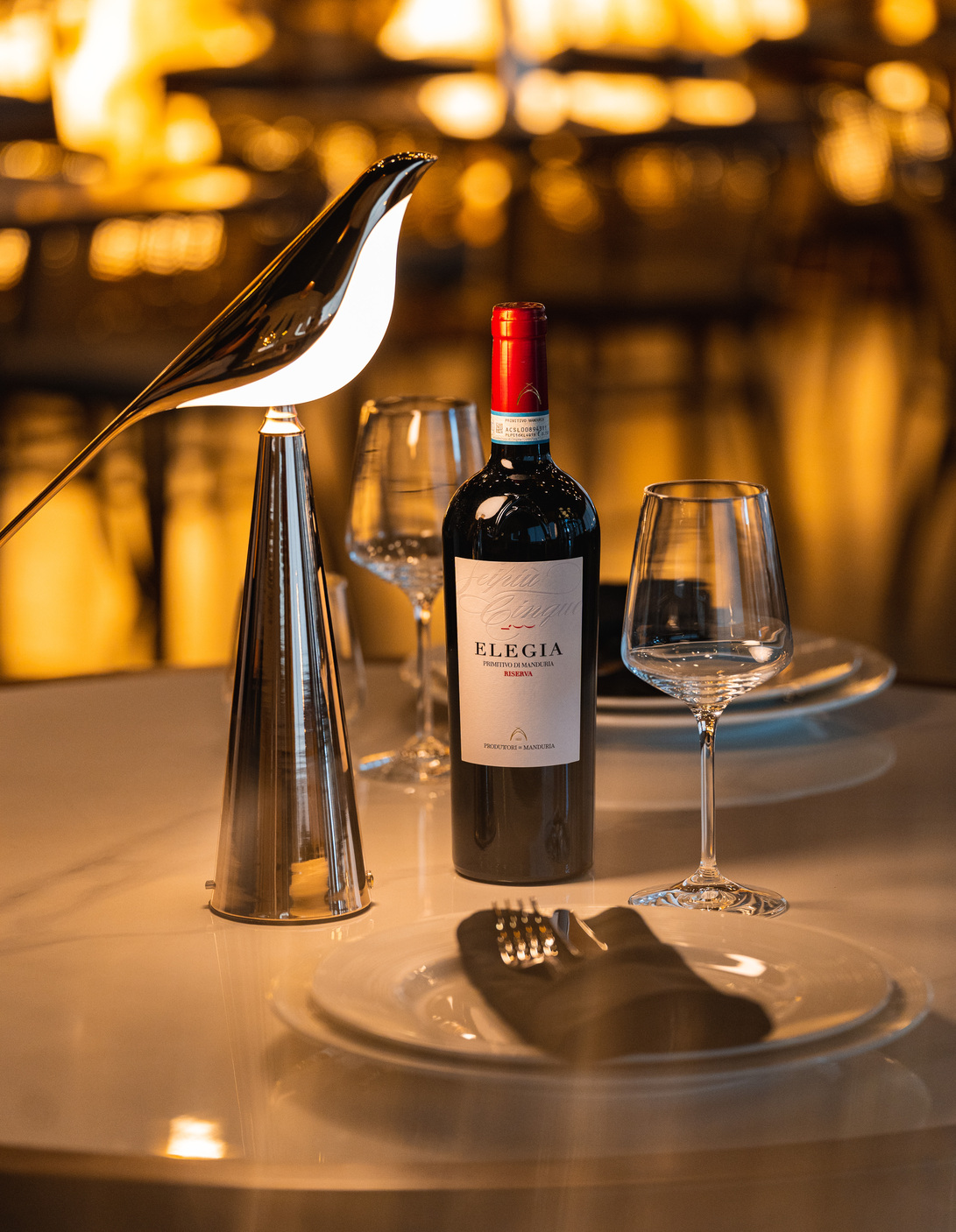 A bottle and glasses at Amami Italia